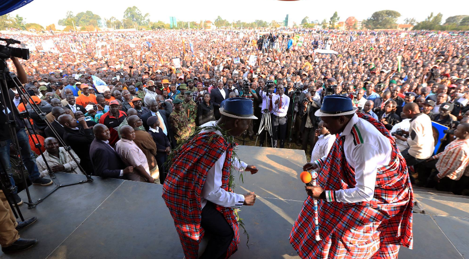 Raila and Odinga dancing in their campaign rally in Eldoret